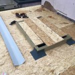 Chipping wood on flat roof extension with building accessories on