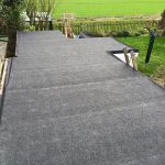 large grey flat roof on a garden outbuilding