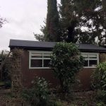 Finished garden shed with a black roof